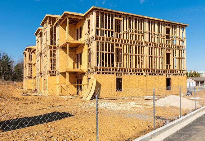 a close-up of temporary chain link fences enclosing a job site, signaling progress in the project's development in Osceola